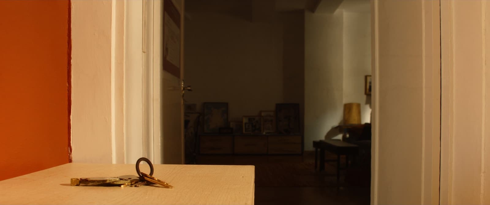 Keys on a console table in the sunlit hallway of a Lisbon apartment